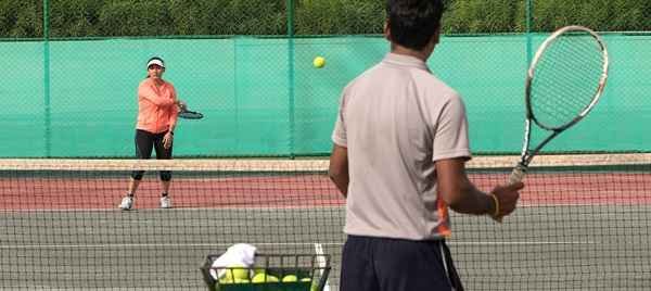 Residents play tennis in the DLF Camellias Gurgaon community.